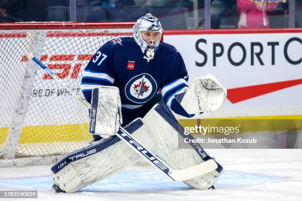 Goaltender Connor Hellebuyck of the Winnipeg Jets takes part in the pre-game warm up prior to NHL action against the Nashville Predators at Canada...