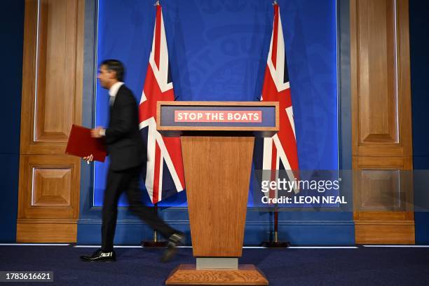 Britain's Prime Minister Rishi Sunak leaves the stage at the end of a press conference, following the Supreme Court's Rwanda policy judgement, at...