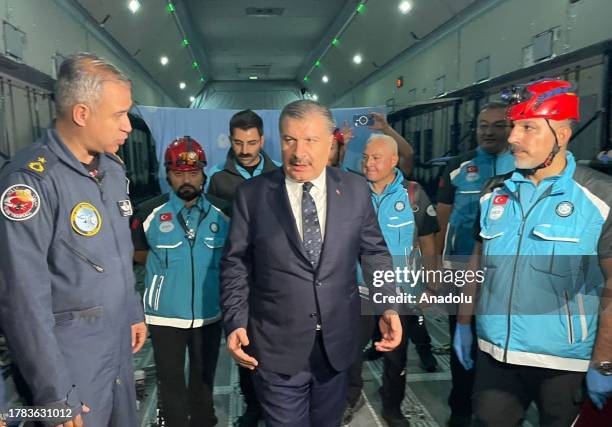 Turkish Health Minister Fahrettin Koca inspects the plane bringing injured people from Gaza at El Arish International Airport in Arish, Egypt on...