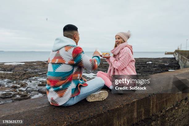 eating chips by the sea - 25 january stock pictures, royalty-free photos & images