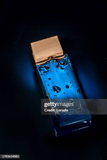 perfume bottle in water reflection - aftershave bottle stock pictures, royalty-free photos & images