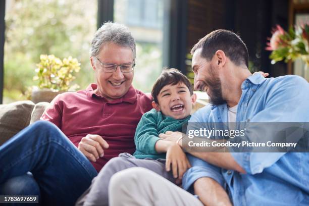 adorable little boy laughing with his dad and grandfather at home - grandpa son stock pictures, royalty-free photos & images