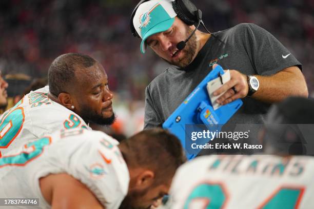 Miami Dolphins defensive line coach Austin Scott reviews film on a Microsoft Surface tablet with Raekwon Davis vs. New England Patriots at Gillette...