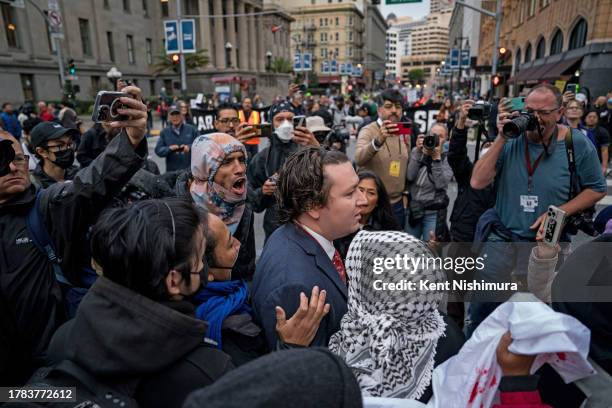 Protestors trying to block delegates, staff and security personnel from accessing security check points to enter the APEC summit zone at Moscone...