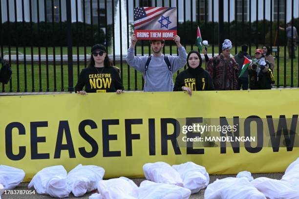 Demonstrators supporting Israel hold signs next to demonstrators calling for a ceasefire, in front of the White House in Washington, DC, on November...