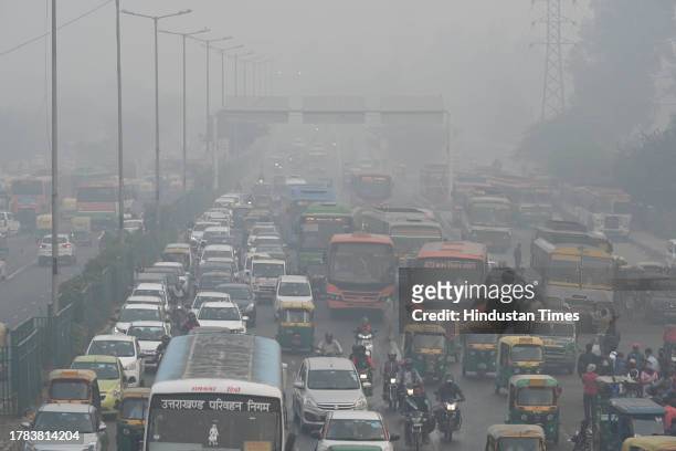 Commuters out on cold morning amid hazy weather conditions and smog at Anand Vihar, on November 15, 2023 in New Delhi, India.