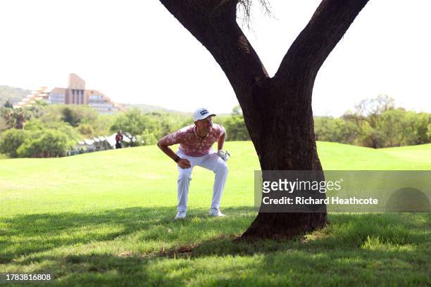 Adrian Meronk of Poland plays his second shot from behind a tree on the 10th hole during Day One of the Nedbank Golf Challenge at Gary Player CC on...