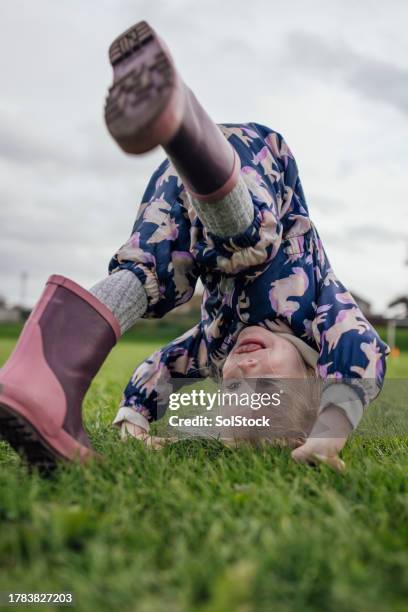 rolling around the park - girl upside down stock pictures, royalty-free photos & images