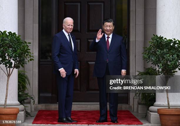 President Joe Biden greets Chinese President Xi Jinping before a meeting during the Asia-Pacific Economic Cooperation Leaders' week in Woodside,...