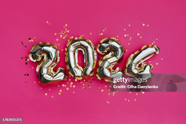 golden numbers 2024 balloons on raspberry color background with confetti. new year is coming - glitter fruit stock pictures, royalty-free photos & images
