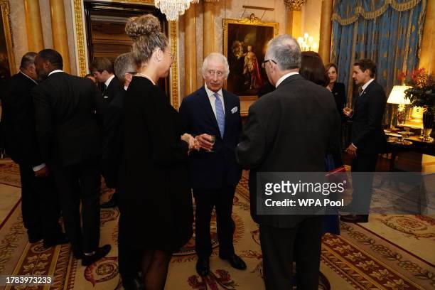 King Charles III meets guests during a reception for delegates of the Overseas Territories Ministerial Council during at Buckingham Palace on...