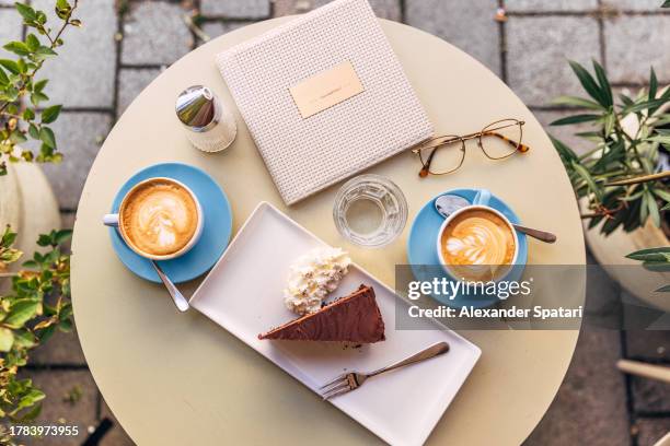 sachertorte and coffee served in a sidewalk cafe, vienna, austria - torte wien foto e immagini stock