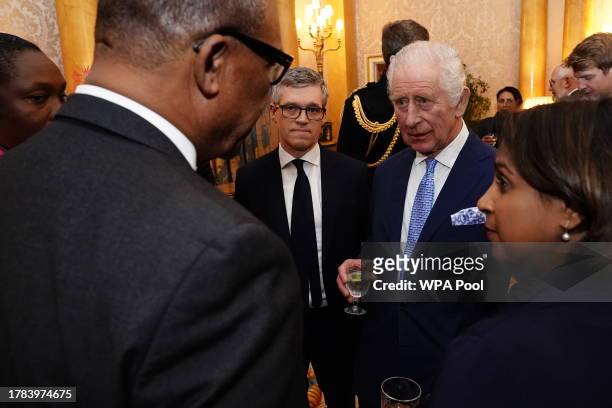 King Charles III meets guests during a reception for delegates of the Overseas Territories Ministerial Council during at Buckingham Palace on...