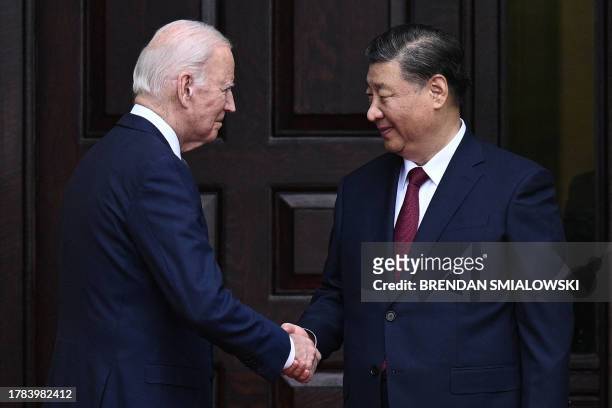 President Joe Biden greets Chinese President Xi Jinping before a meeting during the Asia-Pacific Economic Cooperation Leaders' week in Woodside,...