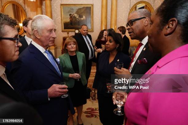King Charles III speaks with Governor of Bermuda Rena Lalgie and Premier and Minister of Finance of Bermuda David Burt during a reception for...