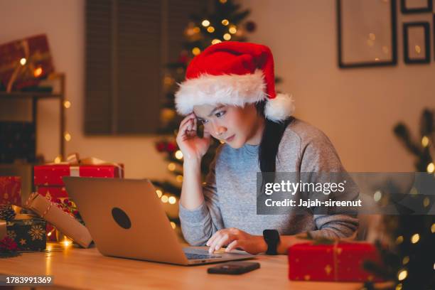 asian woman have a problem with work, sitting at home office on christmas day. - parcel laptop stock pictures, royalty-free photos & images