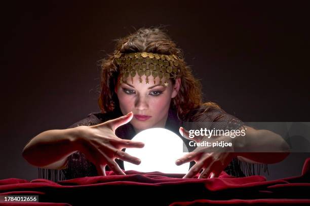 mysterious looking fortune teller - forecasting stock pictures, royalty-free photos & images