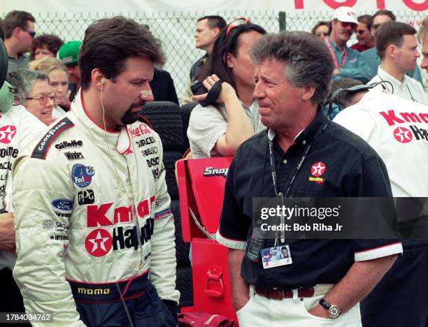 Racer Michael Andretti with his father and Team Owner former Racer Mario Andretti along pit row at Long Beach Grand Prix Race, April 3, 1998 in Long...