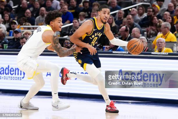 Tyrese Haliburton of the Indiana Pacers dribbles the ball while being guarded by Keyonte George of the Utah Jazz in the first quarter at Gainbridge...