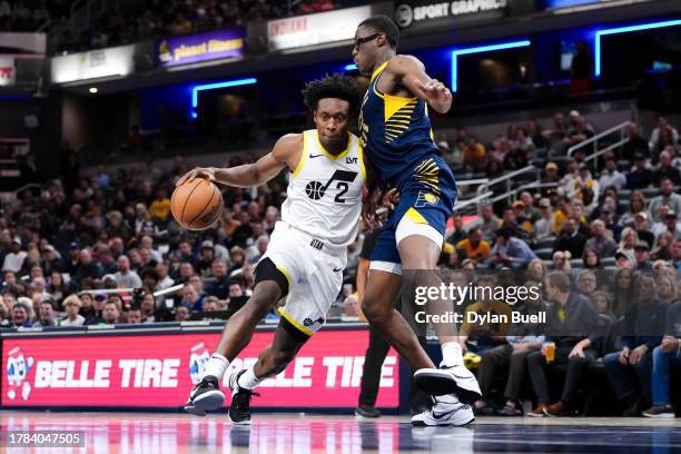 Collin Sexton of the Utah Jazz dribbles the ball while being guarded by Jalen Smith of the Indiana Pacers in the fourth quarter at Gainbridge...