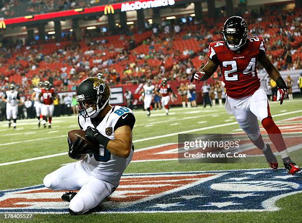 Jeremy Ebert of the Jacksonville Jaguars pulls in a touchdown reception against Dominique Franks of the Atlanta Falcons at Georgia Dome on August 29,...