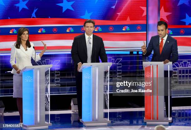 Republican presidential candidate former U.N. Ambassador Nikki Haley puts her hand up to Vivek Ramaswamy while he speaks to her as Florida Gov. Ron...