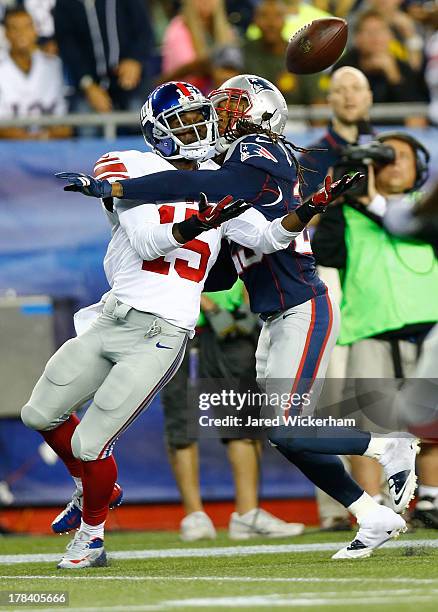 Marquice Cole of the New England Patriots defends a pass in front of Kevin Hardy of the New York Giants during the preseason game at Gillette Stadium...
