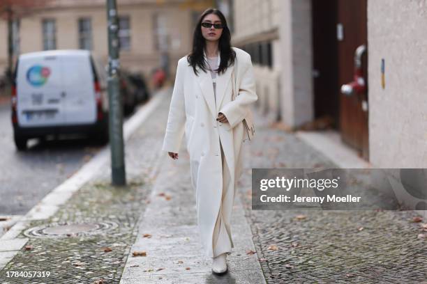 Milena Karl seen wearing Saint Laurent black sunglasses, Orse und Iris white transparent top, Massimo Dutti white suit pants, The Frankie Shop cream...