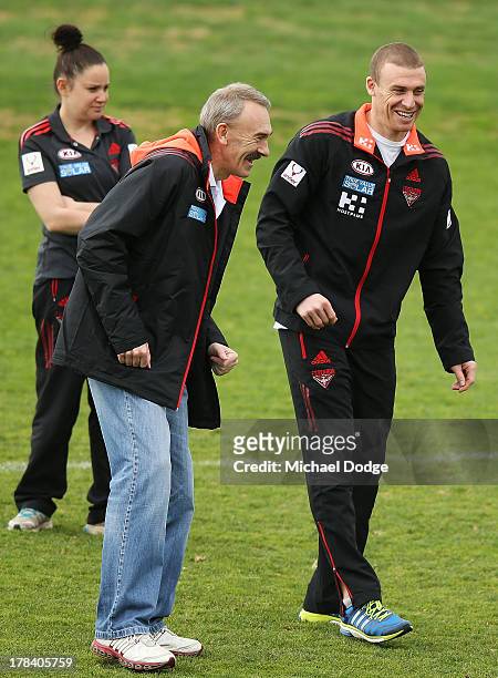 Bombers interim senior coach Simon Goodwin and CEO Ray Gunston react during an Essendon Bombers training session at Windy Hill on August 30, 2013 in...