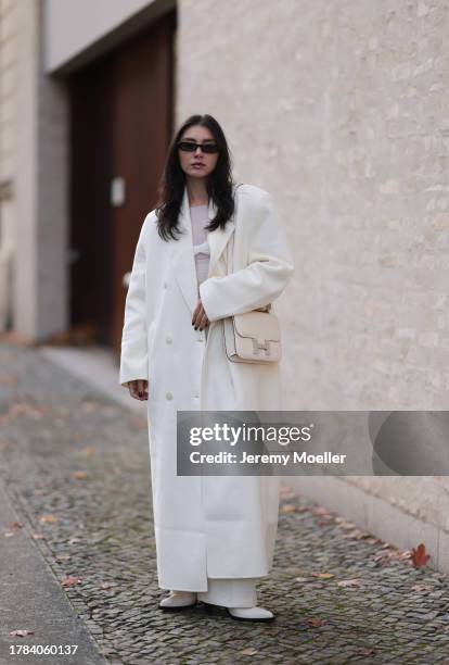 Milena Karl seen wearing Saint Laurent black sunglasses, Orse und Iris white transparent top, Massimo Dutti white suit pants, The Frankie Shop cream...