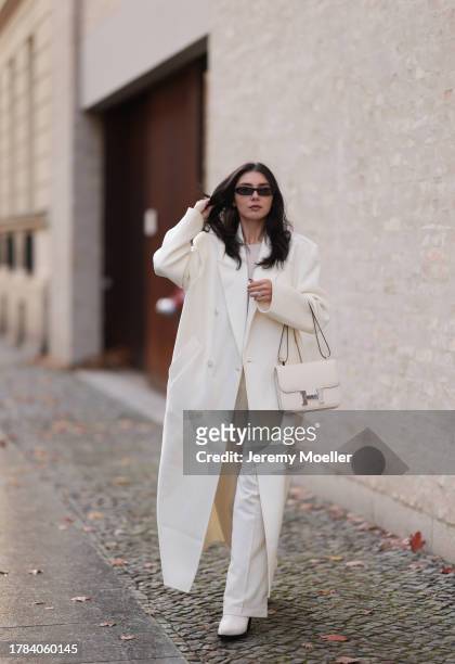 Milena Karl seen wearing Saint Laurent black sunglasses, Orse und Iris white transparent top, Massimo Dutti white suit pants, The Frankie Shop cream...