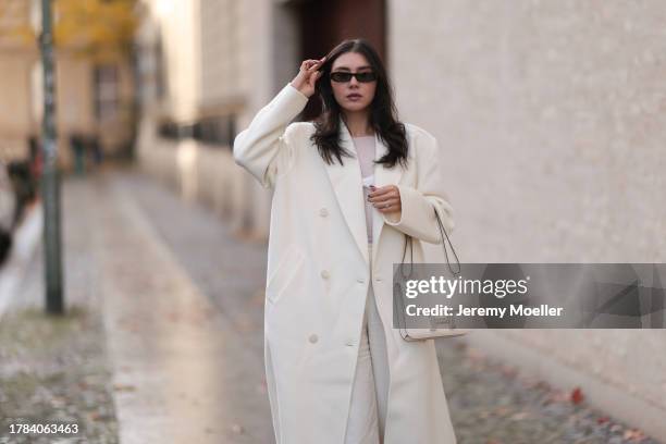 Milena Karl seen wearing Saint Laurent black sunglasses, Orse und Iris white transparent top, Massimo Dutti white suit pants, The Frankie Shop cream...