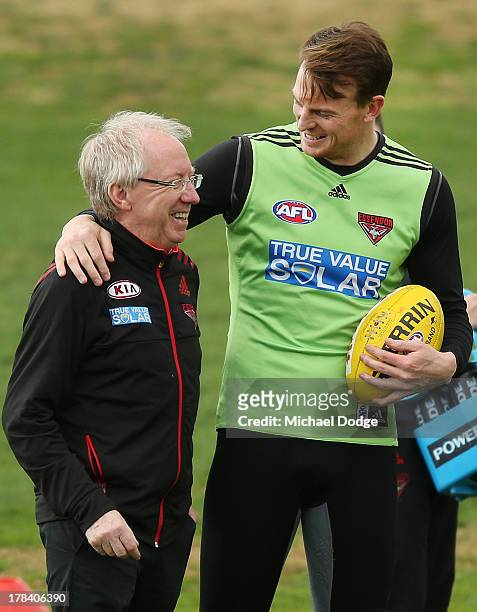 Bombers doctor Bruce Reid gets hugged by Brendon Goddard during an Essendon Bombers training session at Windy Hill on August 30, 2013 in Melbourne,...