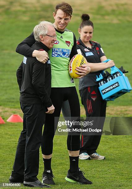 Bombers doctor Bruce Reid gets hugged by Brendon Goddard during an Essendon Bombers training session at Windy Hill on August 30, 2013 in Melbourne,...