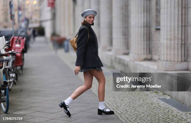 Mary L. Jean seen wearing silver earrings, Ganni grey wool knit beret / hat, Ganni dark grey wool blazer jacket, Aritzia grey striped pleated short...