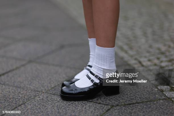 Mary L. Jean seen wearing white cotton socks and Jonak black varnished leather ballet flats, on November 09, 2023 in Berlin, Germany.