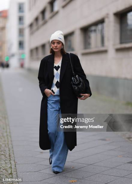 Mary L. Jean seen wearing silver earrings, Ganni white wool knit beanie, Zara cream white / colorful printed wool knit sweater, Herskind black wool...