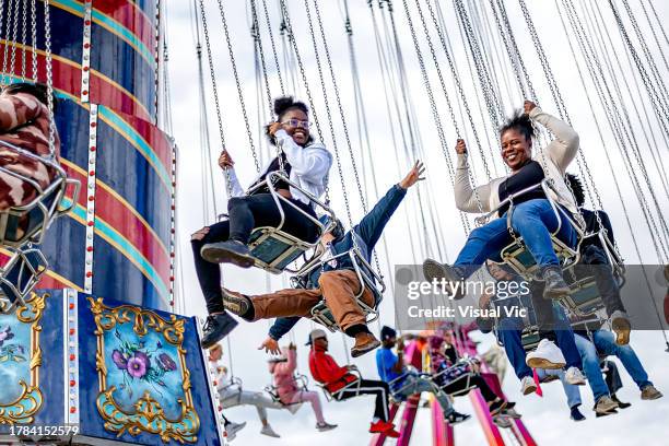 family enjoying carnival ride - exhibition a human adventure stock pictures, royalty-free photos & images