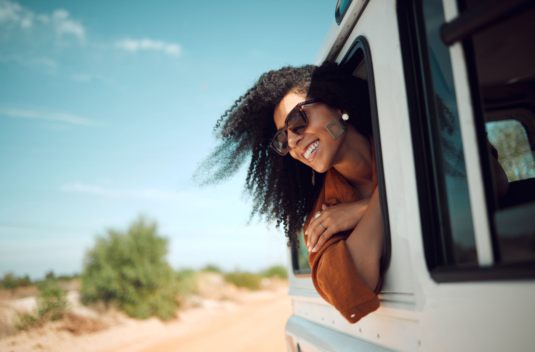 Travel, road trip and woman by car window for adventure, nature freedom and outdoor lifestyle on summer blue sky mockup, Girl in sunglasses and van drive by bush or countryside for holiday experience Travel, road trip and woman by car window for adventure, nature freedom and outdoor lifestyle on summer blue sky mockup, Girl in sunglasses and van drive by bush or countryside for holiday experience