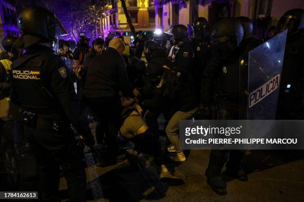 Riot police and plain-clothed officers drag a detained demonstrator during a protest called by right-wing opposition against an amnesty bill for...