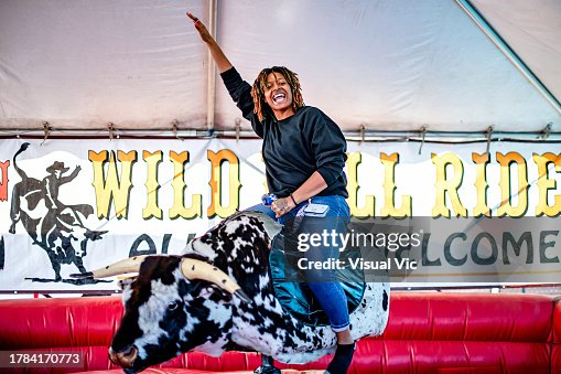Woman riding mechanical bull Woman riding mechanical bull
