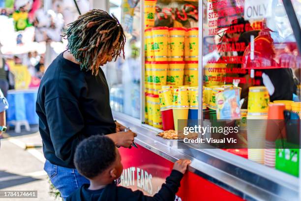 buying a funnel cake at fair - funnel cake stock pictures, royalty-free photos & images