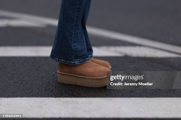 Celine Bethmann seen wearing Zara blue denim jeans / pants, UGG chestnut / brown suede leather platform boots, on November 09, 2023 in Berlin,...