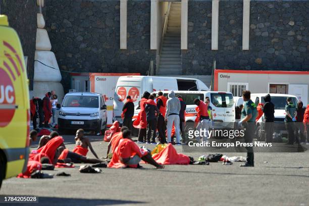 Several migrants are attended by emergency services, at the dock of La Restinga, on November 9 in El Hierro, Canary Islands, Spain. A new cayuco has...