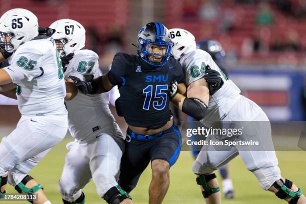 Mustangs defensive end Cameron Robertson breaks through the North Texas Mean Green offensive line during the college football game between the SMU...