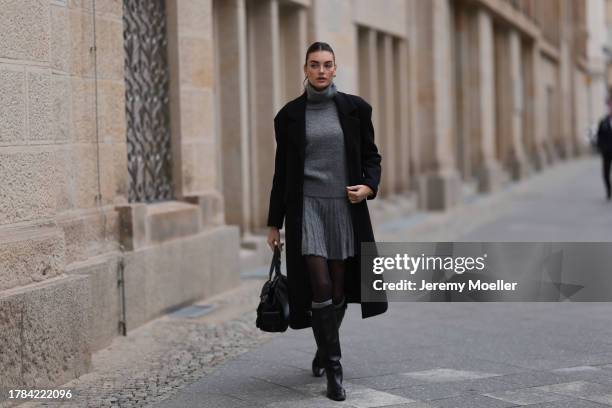 Celine Bethmann seen wearing gold earrings, Zara grey high neck wool knit pullover, matching Zara grey wool knit short skirt, Zara x Ader Error...