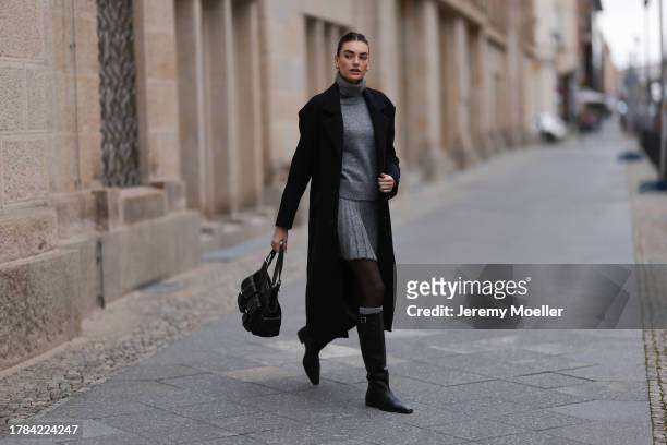 Celine Bethmann seen wearing gold earrings, Zara grey high neck wool knit pullover, matching Zara grey wool knit short skirt, Zara x Ader Error...
