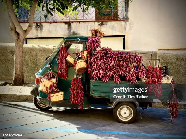 truck covered in red chili peppers and onion/shallots - red bell pepper stock pictures, royalty-free photos & images