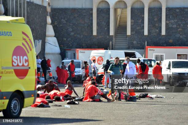 Several migrants are attended by emergency services, at the dock of La Restinga, on November 9 in El Hierro, Canary Islands, Spain. A new cayuco has...