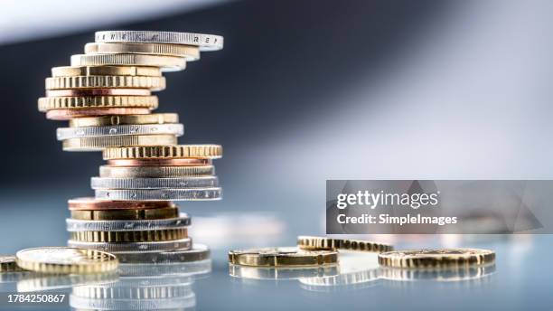 euro coins built in the shape of a tower that balances before falling, a symbol of financial growth and fall - close up. - coins euro bildbanksfoton och bilder
